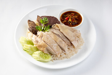 Steamed rice topped with chicken on a white background