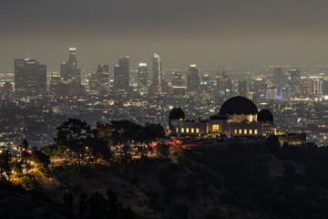 Griffith Observatory at night with the Los Angeles cityscape in background.