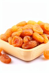 Dried apricots elegantly arranged on wooden stand against clean white background