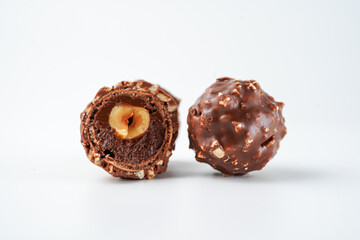 Sweet chocolate balls is made. Chocolate candy in gold wrapper on white background