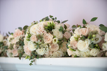 Pink pastel and white roses bridal bouquets lined up on fire place mantle