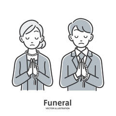 葬儀で手を合わせる男性と女性