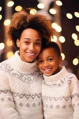 Afro American boy with mother portrait posing with identical Christmas sweaters