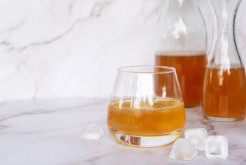 Two glass of homemade Kombucha on the marble table, healthy fermented tea beverages.