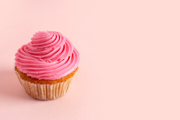 Tasty cupcake on pink background