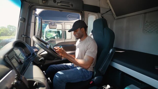 Truck driver using truck gps navigation to looks the route before leaving. Right hand drive car