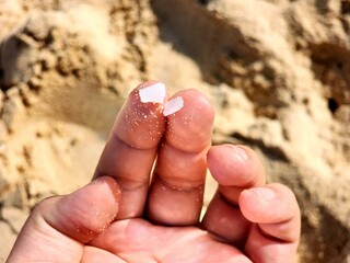 Plastic debris from the beach on your fingertips