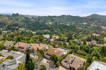 Fototapeta premium Aerial view of a residential complex in a green landscape on a sunny day