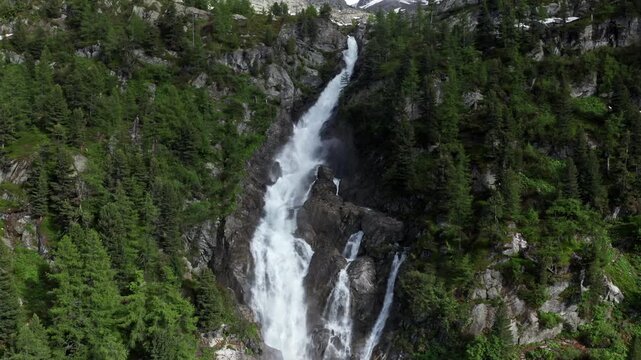 Cascate del Rutor waterfall cascading down a lush green mountainside in Italy