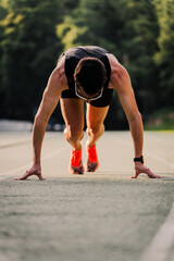 Pro runner ready to go during the race on the running track. Vertical