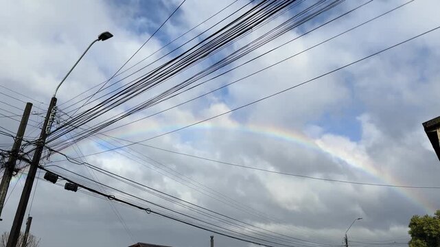 street corner light cables embellish by a circular southern rainbow