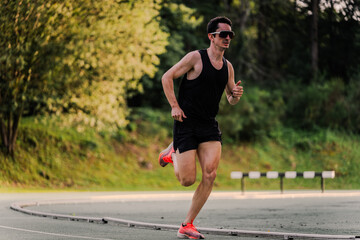 Professional athlete wearing sunglasses running the last meters of the race