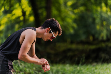 Close-up shot of an expert runner synchronizing his smartwatch before the start of the race