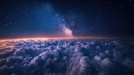 Fototapeta premium A stunning image of a night sky viewed from above the clouds, with a sea of white clouds stretching out under the stars.