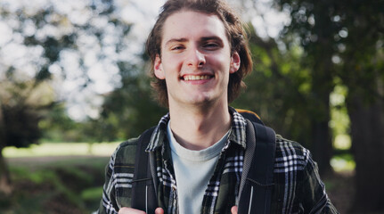 Portrait, man and hiking for fitness outdoor with backpack adventure, trekking mission and forest journey. Smile, male person and travel for walking exercise, climbing and morning path in nature