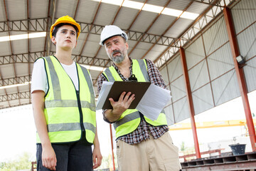 Engineers team talking about working plan at construction site.