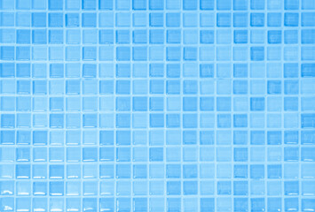 Fototapeta premium Blue light ceramic wall chequered and floor tiles mosaic background in bathroom. Design pattern geometric with grid wallpaper texture decoration pool. Simple seamless abstract surface clean.