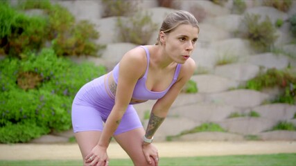 Fit and beautiful woman takes a well deserved break during her outdoor workout, showcasing her impressive athletic skills and unwavering dedication to maintaining a healthy and active lifestyle