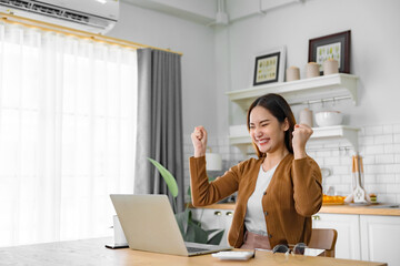 Funny euphoric young asian woman celebrating winning or getting ecommerce shopping offer on...