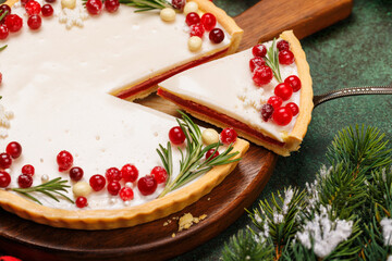 Christmas cake adorned with berries and rosemary
