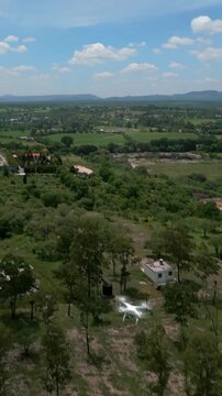 Dji drone used for topography flying in the air.
Descending from a cloudy sky to the countryside. Aerial drone