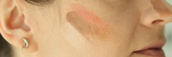 Fototapeta premium Woman face with tone cream lines on skin