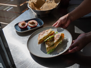 Chef prepares flatbread with salmon. Quesadilla. 