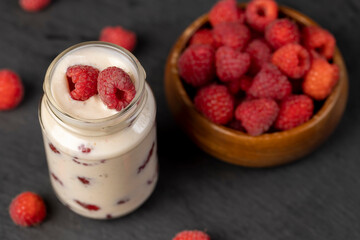 delicious and fresh yogurt with raspberry flavor and whole red raspberries