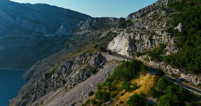Drone following a mountainous road on the Makarska riviera, sunny day in Croatia