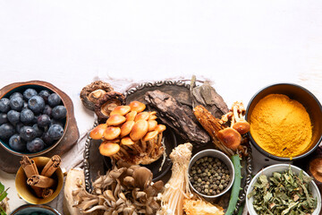 Healthy natural adaptogen. Herbs, spices, mushrooms on light background. Nervine food collection