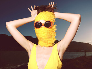 Keywords woman, yellow dress, sunglasses, bandana, body of water, mountains description a woman in...