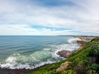 Fototapeta premium Newcastle's coastal panorama combines Australian Coastline beach landscapes, city views set against the Tasman Sea, view from from the iconic Memorial Walk, Newcastle, Australia