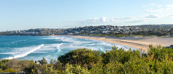 South Curl Curl Beach in Sydney showcases a panoramic coastline with Sydney Cityscape on the background, a popular destination on the Northern Beaches, Australia