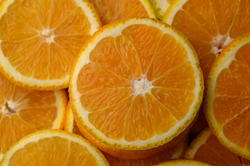 Colorful orange fruit slices background.