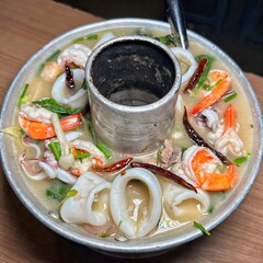 close up sour hot and spicy seafood soup in street food of thailand