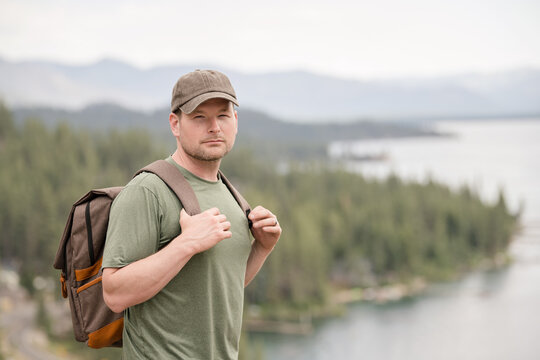 Male hiker looking serious with a beautiful scenery behind