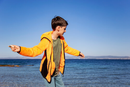 Boy skipping stones by the sea