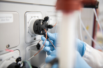 Scientist making adjustments to a machine in a biotech lab