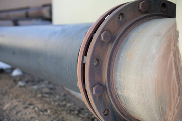 Large industrial horizontal water pipe with rusted fittings