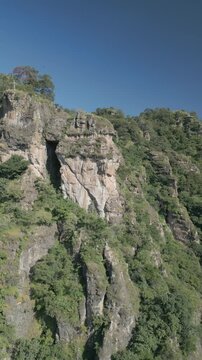 Vertical drone video. Rock formations, forested mountains