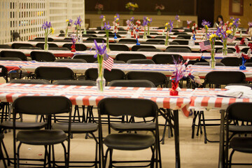 Banquet tables with flowers and American flags