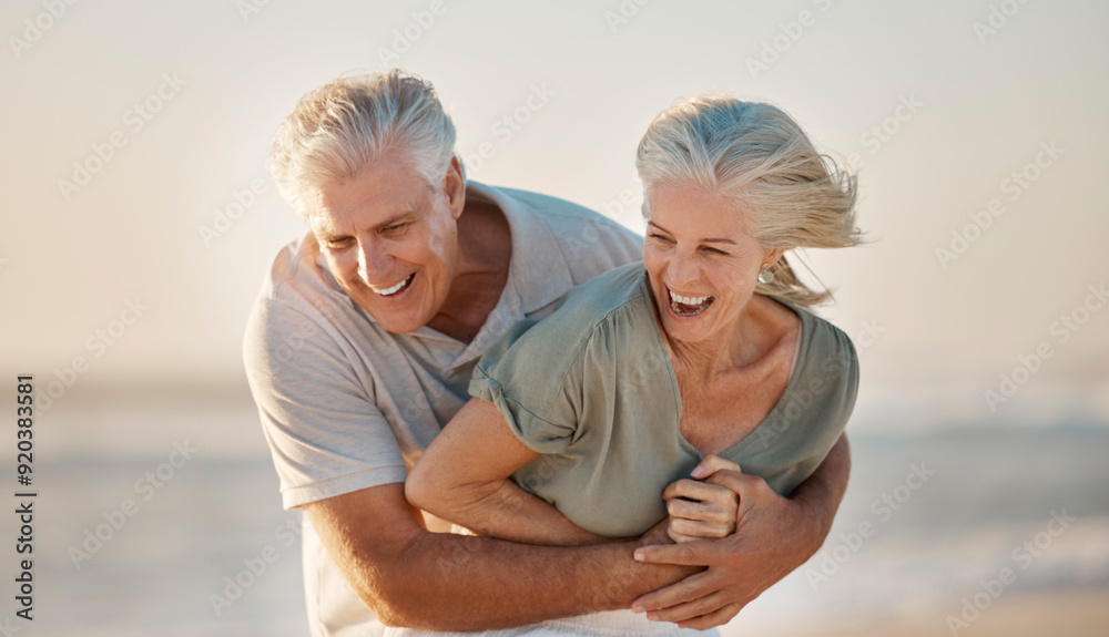 Wall mural Hug, laughing and love with old couple on beach together for holiday, travel or vacation in summer. Funny, romance or smile with elderly man and woman embracing on coast for bonding or having fun