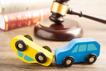 Hammer gavel judge with car vehicle accident, insurance coverage claim lawsuit court case.