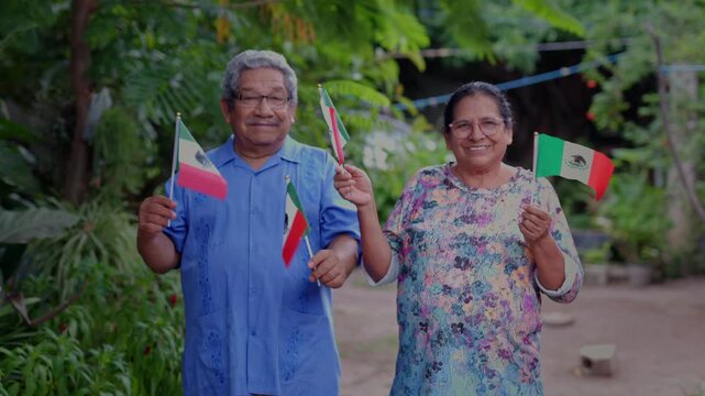 mexican mature couple waving a mexican flag. Independence day concept
