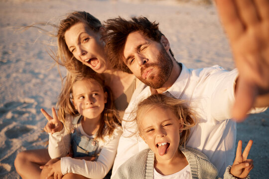 Parents, kids and selfie at beach, funny face or smile with care, love or tongue out for memory in summer. Father, mother and daughter children with peace sign, family or portrait on holiday in Spain