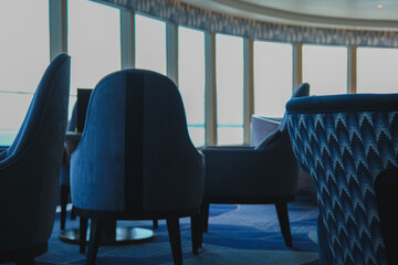 Luxurious observation or panorama lounge with floor to ceiling windows onboard cruiseship or cruise...
