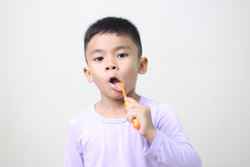 child Asia kid boy brushing teeth isolated on white backgroud.