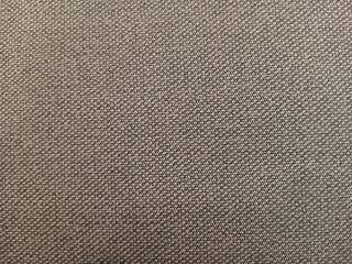 Brownish background fabric wallpaper desk cubical office. Abstract background texture of brown fabric.