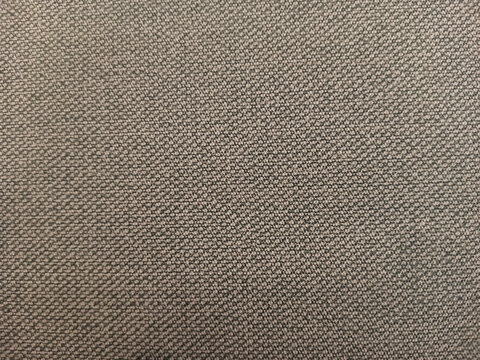 Brownish background fabric wallpaper desk cubical office. Abstract background texture of brown fabric.
