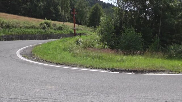 Watching driving from a car in a sharp turn in a mountain environment